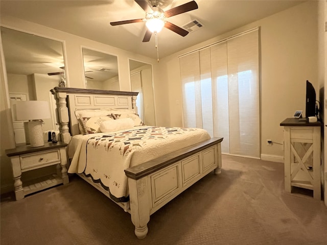 bedroom with a ceiling fan, visible vents, and dark colored carpet