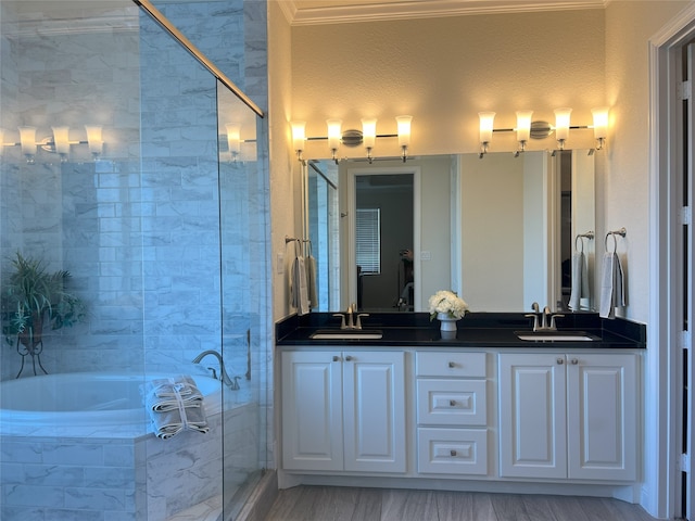 bathroom featuring double vanity, a sink, a bath, and a stall shower