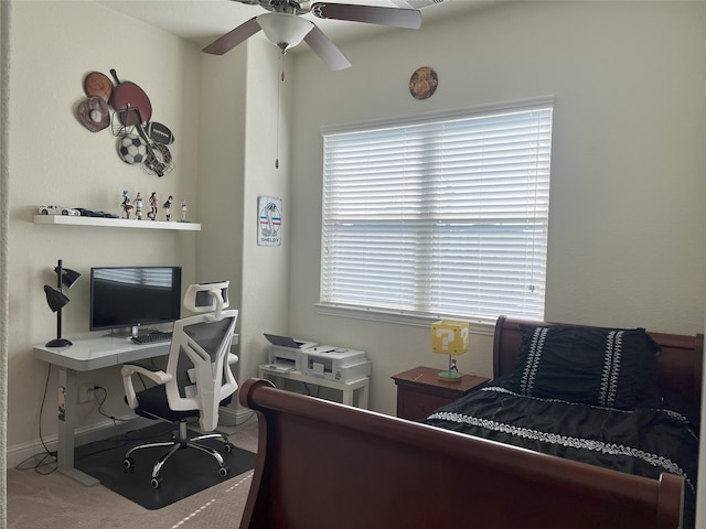 carpeted bedroom featuring baseboards and ceiling fan