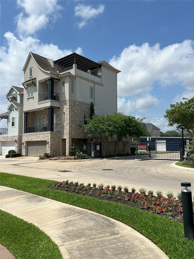 view of building exterior featuring an attached garage, fence, and concrete driveway