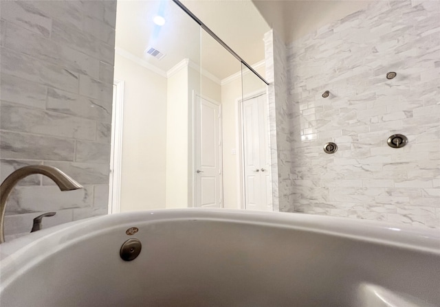 full bathroom with crown molding, a tub, and visible vents