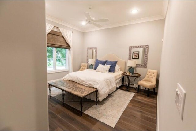 bedroom with ornamental molding, a ceiling fan, and dark wood finished floors