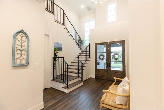 entrance foyer with stairway, french doors, dark wood finished floors, and a healthy amount of sunlight