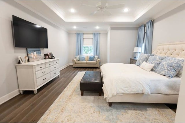 bedroom featuring crown molding, dark wood-style flooring, baseboards, and a raised ceiling
