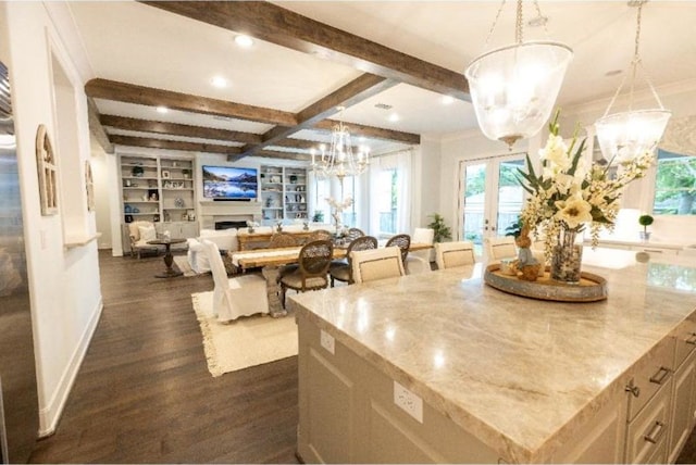 interior space with beamed ceiling, a chandelier, light stone counters, and dark wood-type flooring
