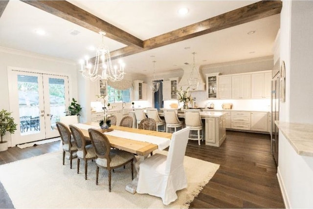 dining space with french doors, dark wood finished floors, beam ceiling, and a chandelier