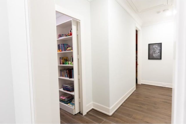 corridor featuring baseboards and wood finished floors