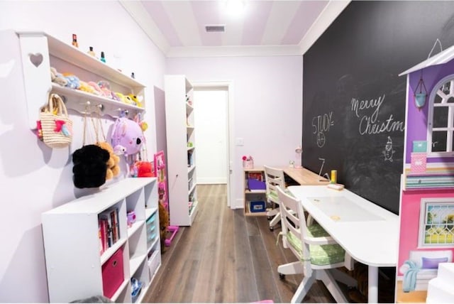 playroom with visible vents, ornamental molding, and wood finished floors