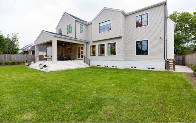 back of property featuring a yard, a fenced backyard, and a patio area