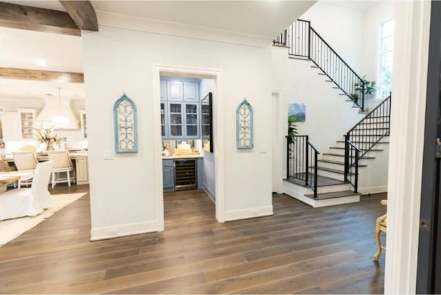 foyer with baseboards, stairs, wine cooler, and dark wood-style floors