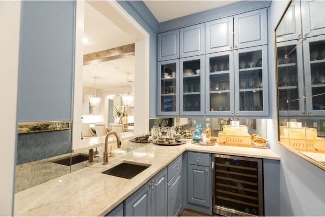bar featuring beverage cooler, bar area, and a sink