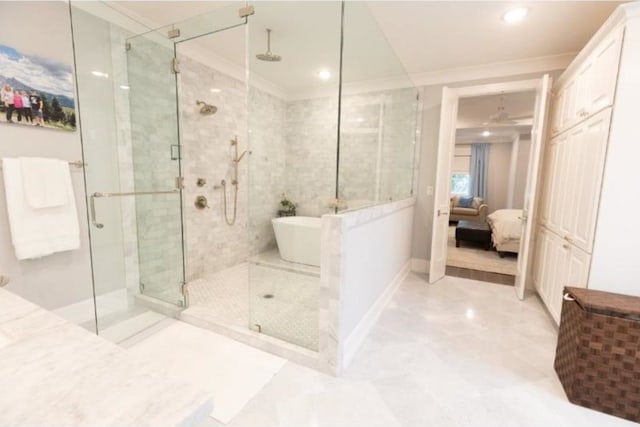 ensuite bathroom with ensuite bathroom, a freestanding bath, a stall shower, baseboards, and ornamental molding