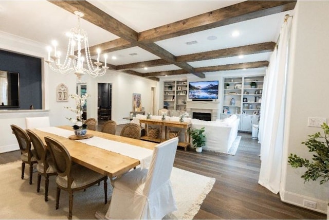 dining room featuring an inviting chandelier, beam ceiling, a fireplace, baseboards, and dark wood-type flooring