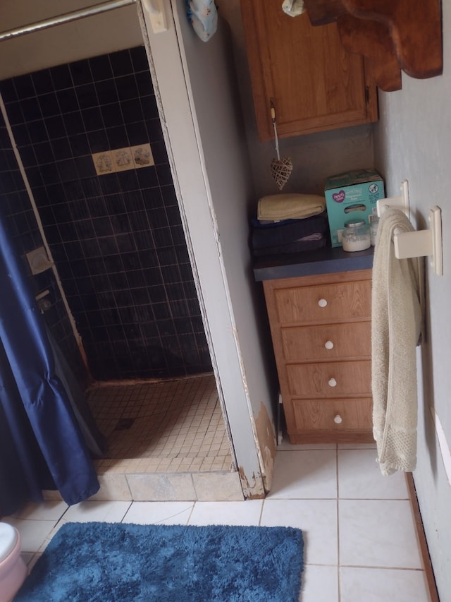 bathroom with tile patterned floors and a shower stall