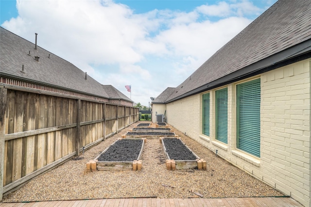 8106 Triumph Bend Way, Magnolia, TX 77354 - view of yard featuring central air condition unit, fence, and a vegetable garden