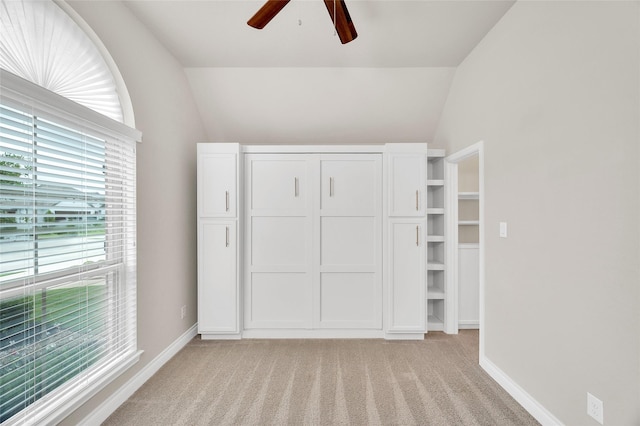 8106 Triumph Bend Way, Magnolia, TX 77354 - unfurnished bedroom featuring multiple windows, lofted ceiling, and light carpet