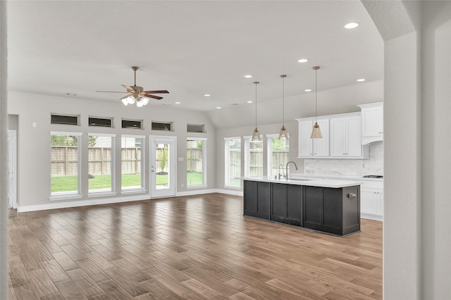 8106 Triumph Bend Way, Magnolia, TX 77354 - kitchen with white cabinets, ceiling fan, a sink, light countertops, and open floor plan