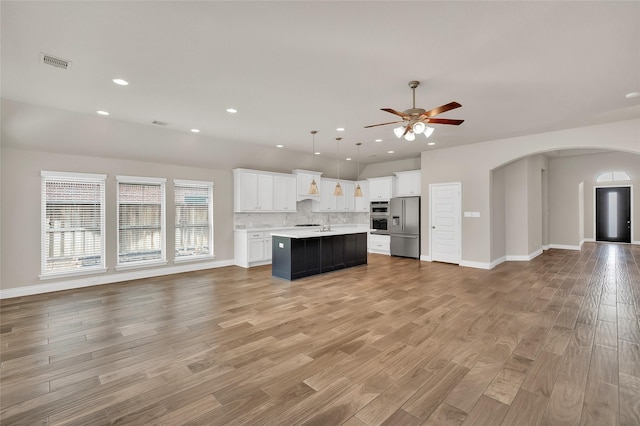 8106 Triumph Bend Way, Magnolia, TX 77354 - kitchen with stainless steel fridge, open floor plan, ceiling fan, and visible vents