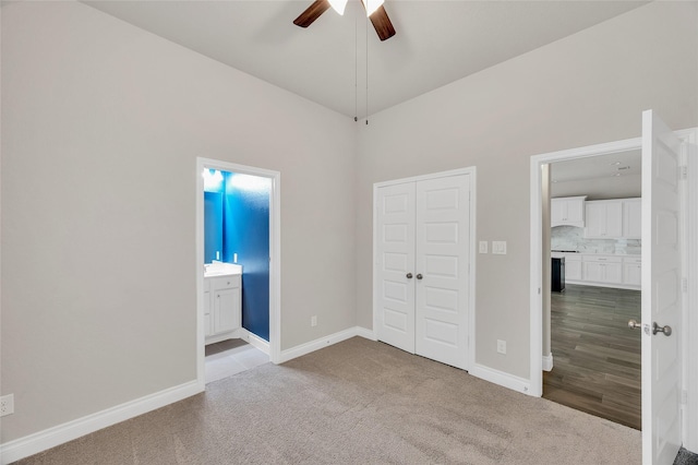 8106 Triumph Bend Way, Magnolia, TX 77354 - unfurnished bedroom featuring connected bathroom, ceiling fan, carpet floors, baseboards, and a closet