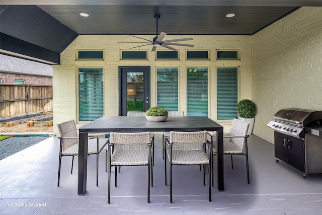 8106 Triumph Bend Way, Magnolia, TX 77354 - view of patio with area for grilling, fence, a ceiling fan, and outdoor dining space