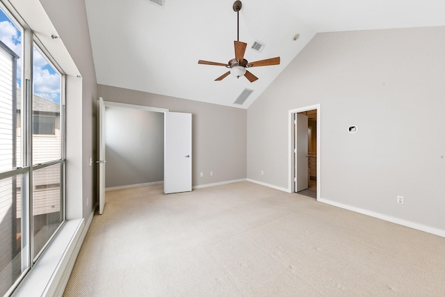 unfurnished bedroom with visible vents, baseboards, high vaulted ceiling, and light colored carpet