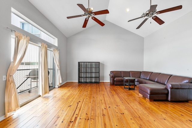living room featuring a ceiling fan, light wood-style flooring, and high vaulted ceiling