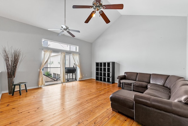 living area featuring high vaulted ceiling, a ceiling fan, and light wood-style flooring