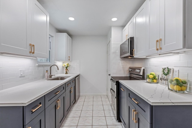 kitchen featuring a sink, tasteful backsplash, stainless steel appliances, and marble finish floor