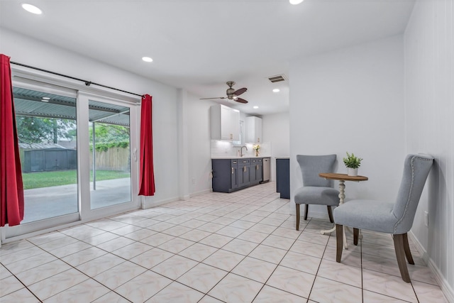 living area with a ceiling fan, visible vents, light tile patterned floors, baseboards, and recessed lighting