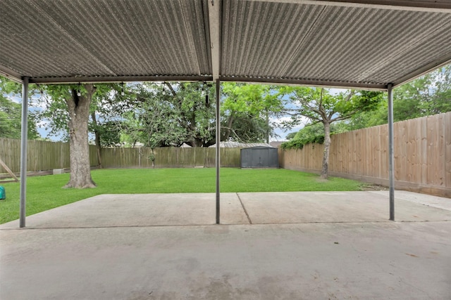 view of patio featuring a fenced backyard, an outdoor structure, and a shed