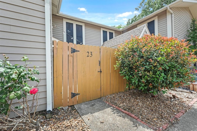 view of side of property with a gate and fence