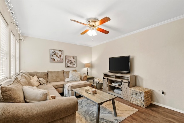 living room featuring crown molding, baseboards, ceiling fan, and wood finished floors