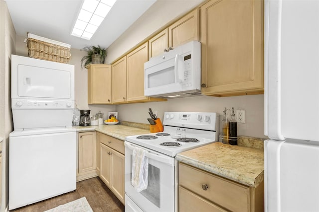kitchen with stacked washer and dryer, light brown cabinetry, white appliances, light countertops, and dark wood finished floors
