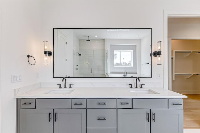 324 W 27th St, Houston, TX 77008 - full bathroom with double vanity, a sink, a spacious closet, and a shower stall