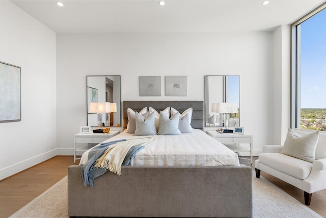 bedroom featuring recessed lighting, baseboards, and wood finished floors