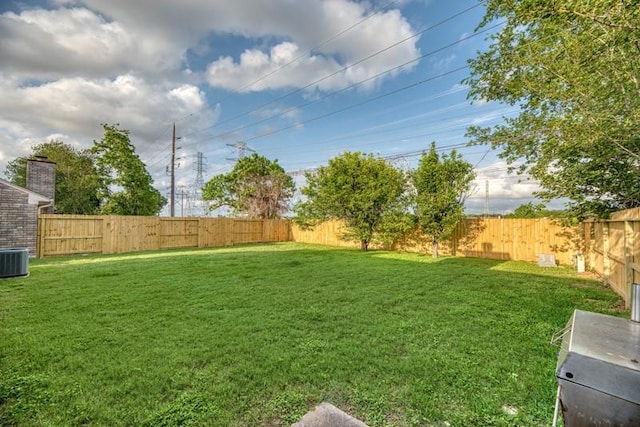 view of yard featuring a fenced backyard and central AC unit