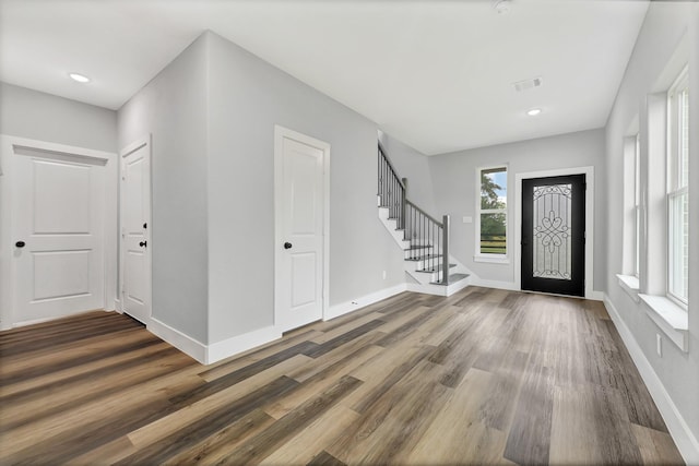 5134 Breckenridge Dr, Houston, TX 77066 - entryway featuring visible vents, baseboards, wood finished floors, and stairway