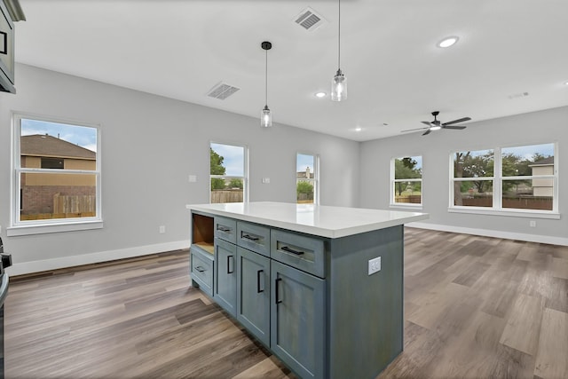5134 Breckenridge Dr, Houston, TX 77066 - kitchen featuring a healthy amount of sunlight, a ceiling fan, wood finished floors, and decorative light fixtures