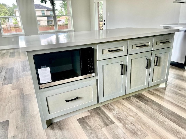 5134 Breckenridge Dr, Houston, TX 77066 - room details featuring light wood-type flooring, light countertops, a kitchen island, and stainless steel appliances