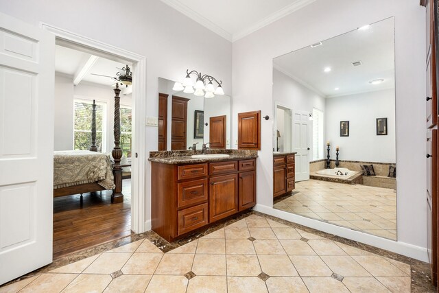 ensuite bathroom with connected bathroom, baseboards, ornamental molding, and tile patterned flooring