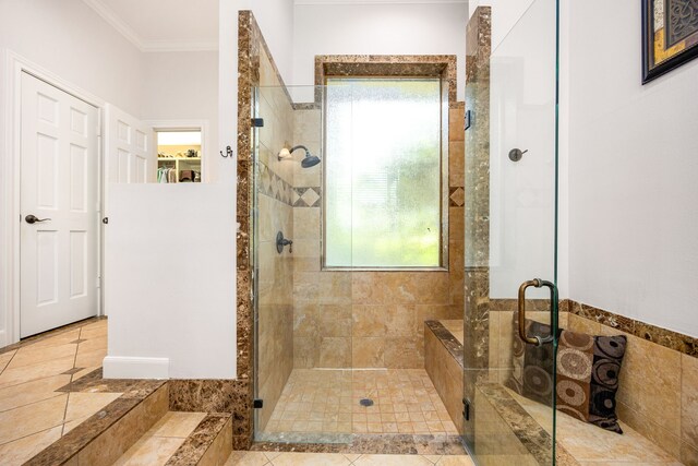 full bathroom featuring tile patterned flooring, ornamental molding, and a stall shower