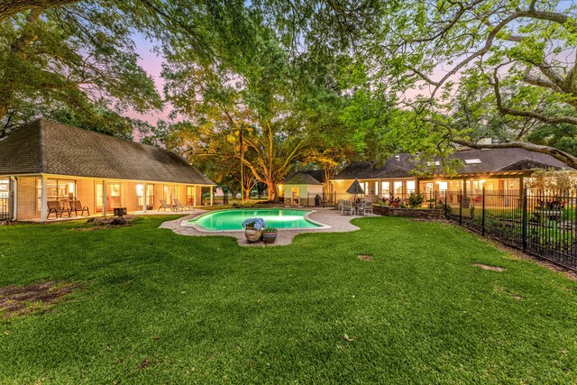 view of yard with a patio, fence, and a fenced in pool