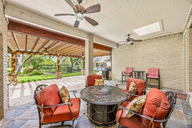 view of patio with a ceiling fan and fence