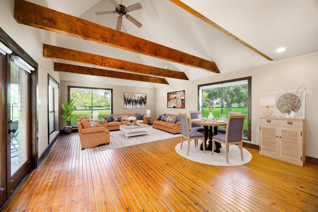living area with recessed lighting, lofted ceiling with beams, and light wood finished floors