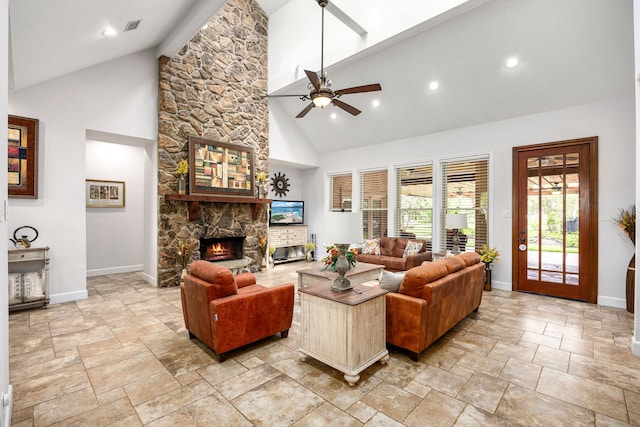 living area with baseboards, high vaulted ceiling, and stone tile flooring