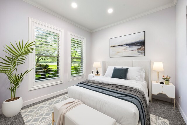 bedroom featuring baseboards, carpet flooring, multiple windows, and ornamental molding