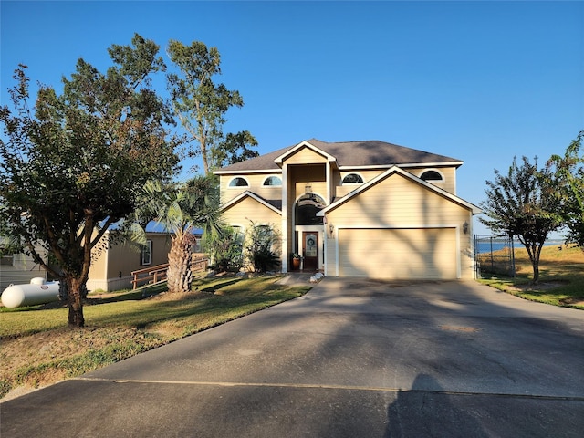 231 Key Largo Loop, Point Blank, TX 77364 - traditional-style house with concrete driveway, fence, a front yard, and a garage