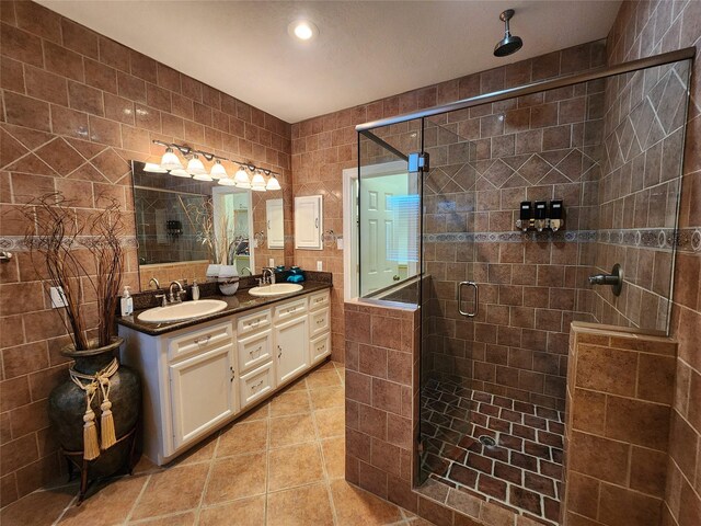 231 Key Largo Loop, Point Blank, TX 77364 - full bath featuring double vanity, a sink, tile patterned floors, and a shower stall