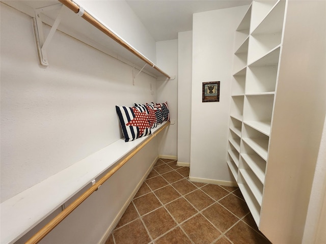 231 Key Largo Loop, Point Blank, TX 77364 - walk in closet featuring dark tile patterned flooring
