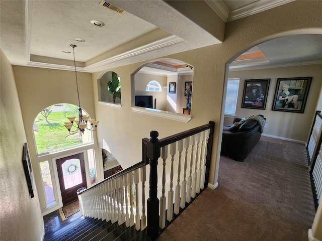 231 Key Largo Loop, Point Blank, TX 77364 - carpeted foyer entrance featuring a raised ceiling, ornamental molding, a notable chandelier, and visible vents
